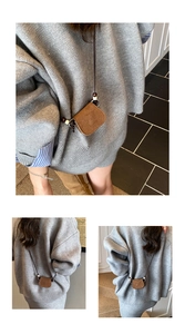 Detail of a brown suede crossbody mini bag with wooden beads and a long shoulder strap