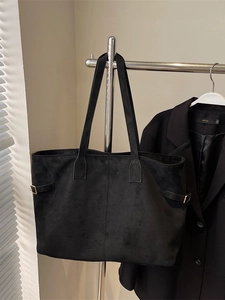 Minimalist black suede tote bag with long straps and metal side buckle for daily commute