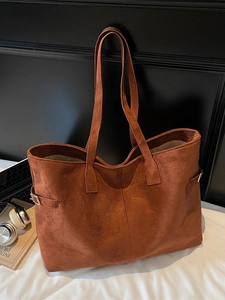 Caramel brown suede tote bag for women shown with laptop in office setting