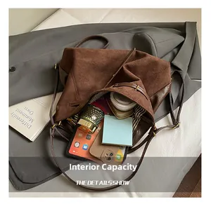 Internal view of a spacious brown tote bag with striped lining and daily essentials