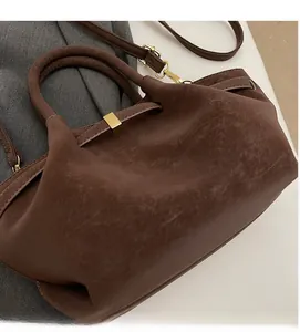 Détails d'un sac à main en cuir texturé vintage avec ornements métalliques dorés