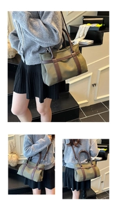 Detail of army green canvas tote with brown leather handles and adjustable straps