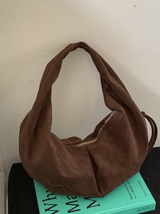 Dark brown suede hobo bag with minimalist moon shape and spacious shoulder design
