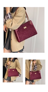 Detail of burgundy suede tote with diamond stitching and golden chain strap