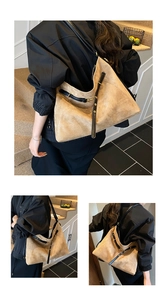 Detail of khaki suede tote bag showing large capacity and black leather shoulder strap