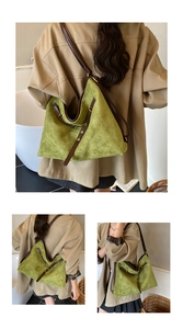 Detailed close-up showing the suede texture and leather strap of this green tote bag