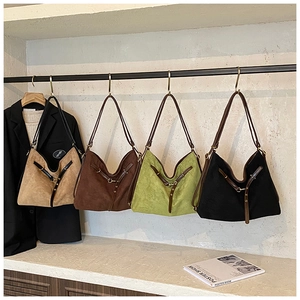 Row of large suede tote bags in khaki, brown, green, and black with leather straps