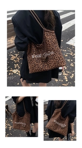 Macro shot of durable leopard print canvas tote bag with reinforced handles and brand text