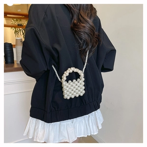 Mini pearl beaded crossbody bag with elegant top handle and delicate chain strap details