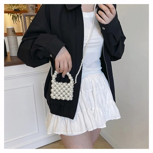 Detailed view of hand-woven pearl mini box bag with elegant pearl strap and top handle
