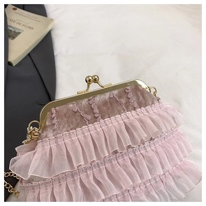 Detail of pink pleated ruffles on qipao bag with vintage gold clasp and metal chain