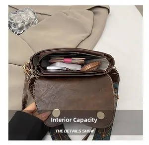 Interior view showing large capacity for phone and wallet in dark brown saddle bag