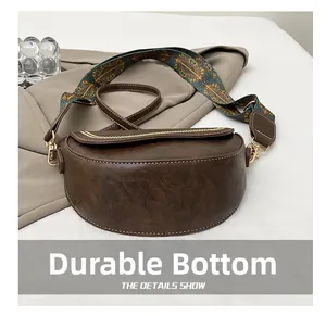Detail showing the wear-resistant bottom and retro printed wide strap of the saddle bag