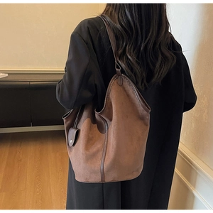 Retro large brown suede tote bag with a small pendant purse shown on a model