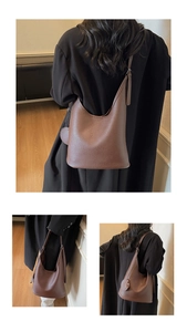Three-way view of a large brown pebble leather hobo bag styled with a long black coat