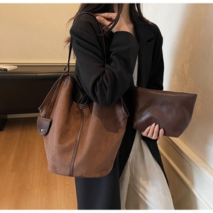Vintage large brown suede tote bag with matching zippered pouch on an Asian model