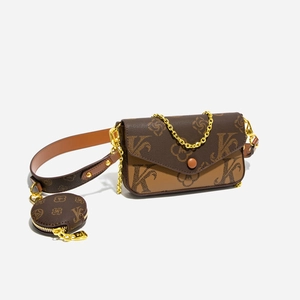 Close-up of retro monogram pattern and gold chain strap on brown two-in-one bag