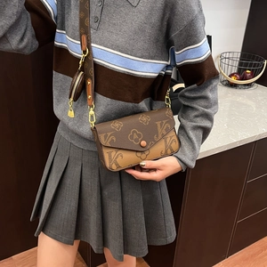 Detail of trendy brown three-in-one crossbody bag with vintage monogram and gold chain