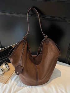 Retro large capacity brown suede tote bag with leather straps on a modern desk setup