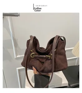 Dettaglio della borsa tote in pelle scamosciata caffè con texture opaca e fibbie dorate