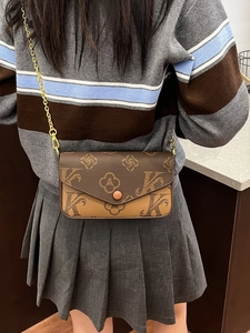 Retro envelope crossbody bag with monogram pattern and gold chain strap in brown