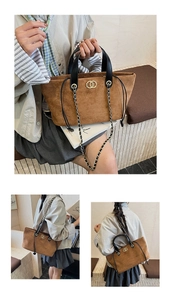 Detail of brown faux suede tote bag featuring gold ring buckle and chain strap
