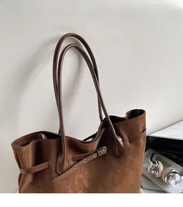 Close-up of adjustable shoulder straps with metal buckles on a vintage tote bag