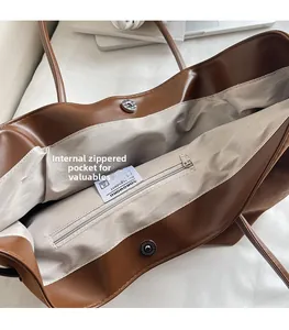 Detail view of large tote bag interior with zipper pocket and magnetic snap closure