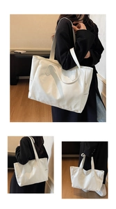 Detail of white tote bag with lychee pattern texture and reinforced side stitching