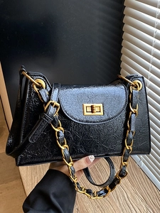 Chic black pleated shoulder bag with gold chain strap and metallic twist lock closure