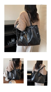 Macro view of textured black PU leather tote bag with sturdy handles and shoulder strap
