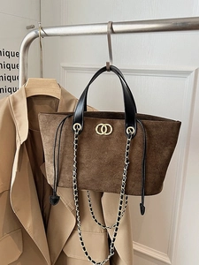 Large dark brown suede tote bag with black leather straps and gold metal hardware