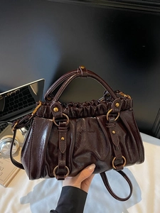 Deep reddish brown pleated handbag with glossy oil leather and gold hardware detail