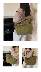 Detail of green suede tote bag with brown leather straps and spacious interior