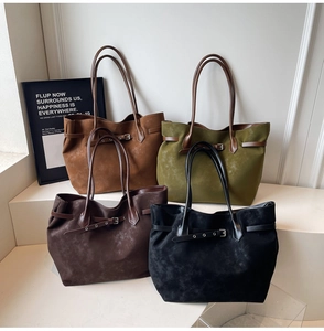 Detail showing four colors of large capacity faux suede tote bags on display steps