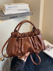 Brown ruched leather tote bag with vintage minimalist design and versatile shoulder strap