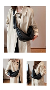 Detail shot of the black crescent hobo bag featuring smooth leather texture and silver hardware