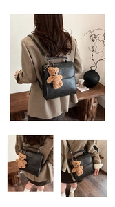 Detail of vintage black matte PU leather backpack with embossed letters and teddy bear charm