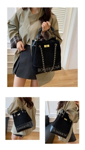 Detail of black quilted bucket bag with golden chain strap and Bowen Nova metal logo