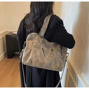 Rear view of a large vintage grey faux leather tote bag with stylish metal zippers