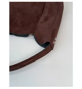 Detail view of reinforced shoulder strap stitching and metal rivets on leopard tote bag