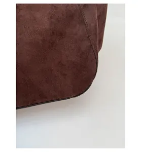 Detailed close-up of dark brown suede tote bag featuring premium texture and black edge finish