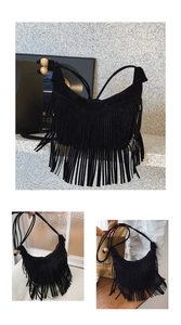 Close-up of black suede crossbody bag featuring dense tassels and decorative wood beads