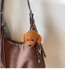 Plush brown poodle bag charm featuring curly fur textures and woven cord accessory