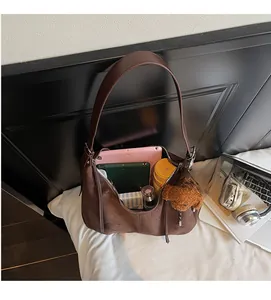 Brown large capacity tote bag interior view with laptop and essentials