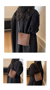 Détail du sac seau marron en similicuir suédé avec une bandoulière au design minimaliste