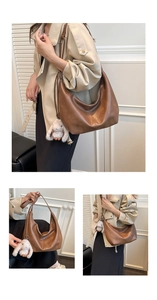 Retro brown crescent hobo bag with a white plush bunny charm on a casual shoulder strap