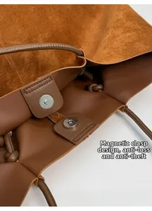 Detail view of the brown suede tote bag featuring dual magnetic closures for secure storage
