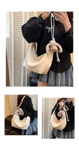 Detailed view of cream PU crescent bag with soft leather texture and cute rabbit charm