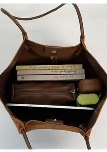 Spacious interior of large brown leopard tote bag with magnetic closure and daily essentials